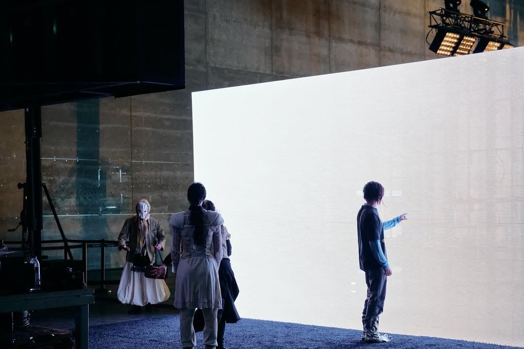 A lit white wall in an empty hall